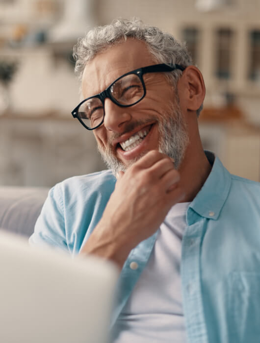 Joyful man with computer on his lap
